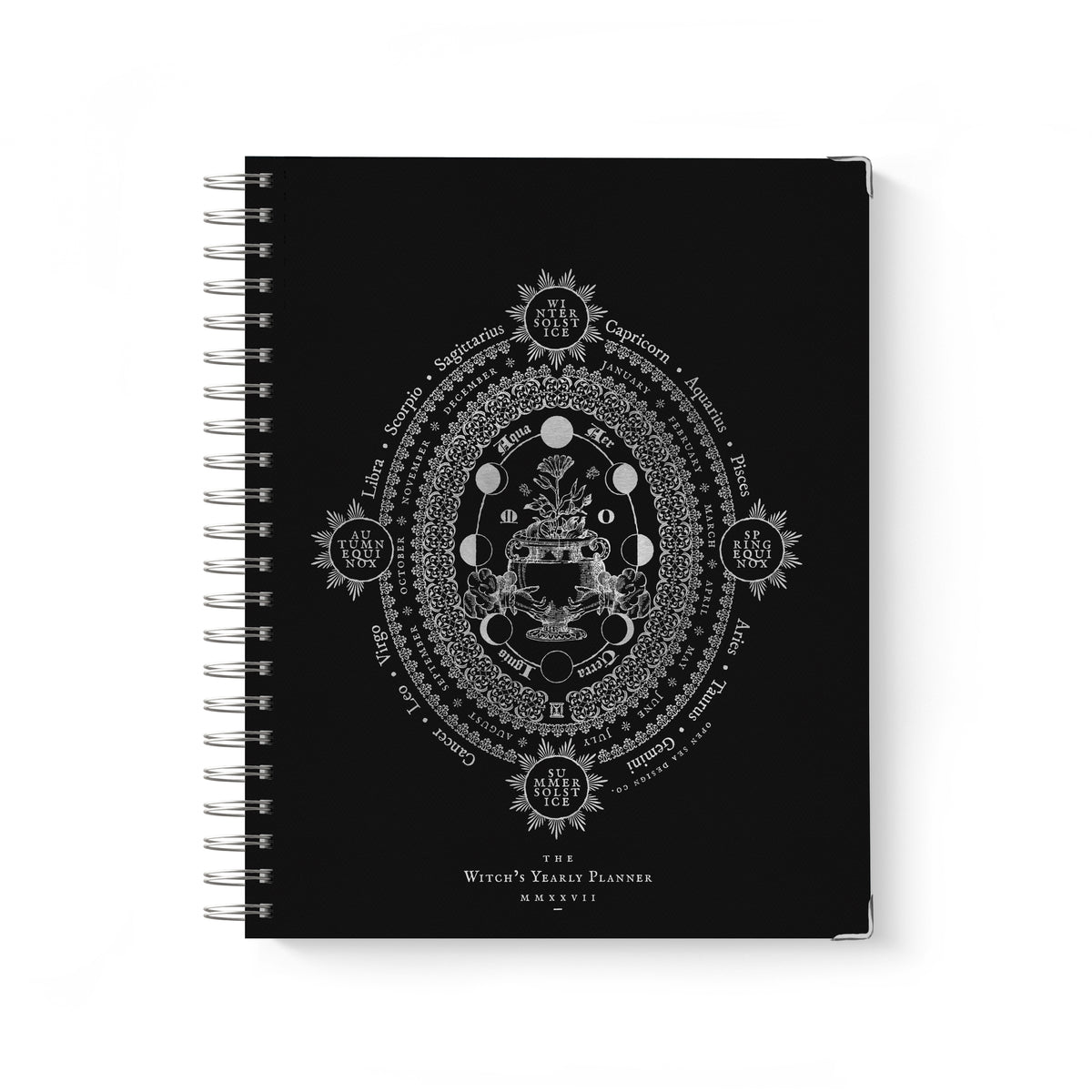 A black spiral-bound notebook featuring a detailed silver-toned occult diagram on the cover, titled 'Witch's Yearly Planner 2027'.
